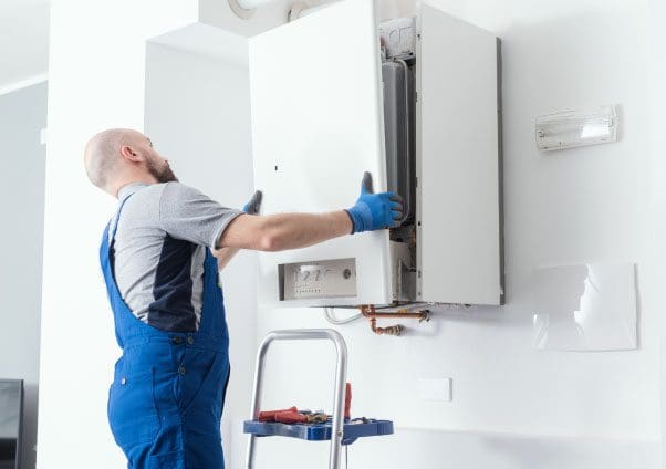 a man installing a boiler